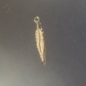Gold feather dagger charm